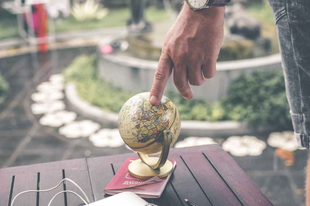 person holding terrestrial globe scale model taken
